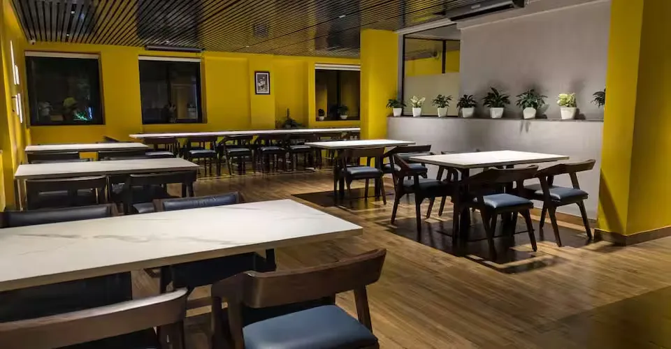 The dine-in floor at night with long white tables