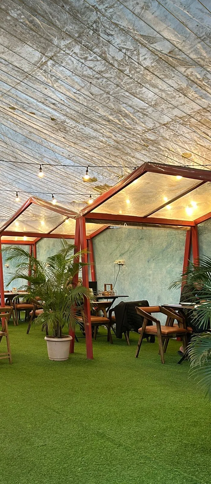 The Pasticceria backyard: gazebos on artificial grass under string lights