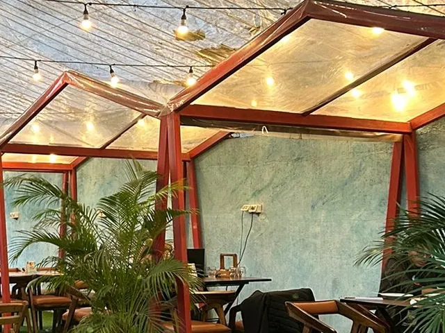The old Felice Pasticceria backyard, with red gazebos and string lights